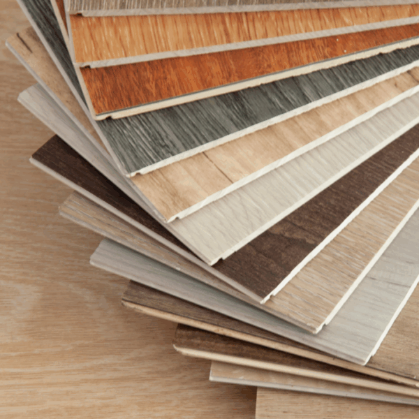 Stack of laminate flooring samples showcasing various wood textures and colors