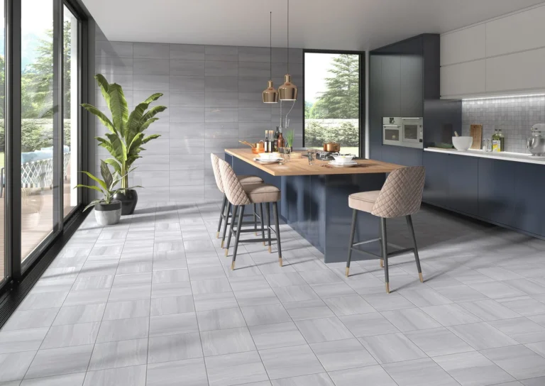 Spacious modern kitchen featuring grey tiled floor and a large island with seating